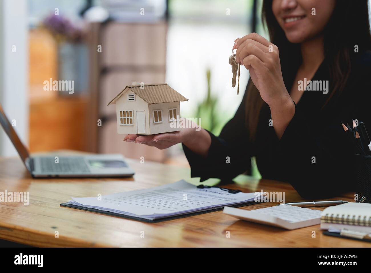 Close up Business woman or Real Estate agent giving house key after ...