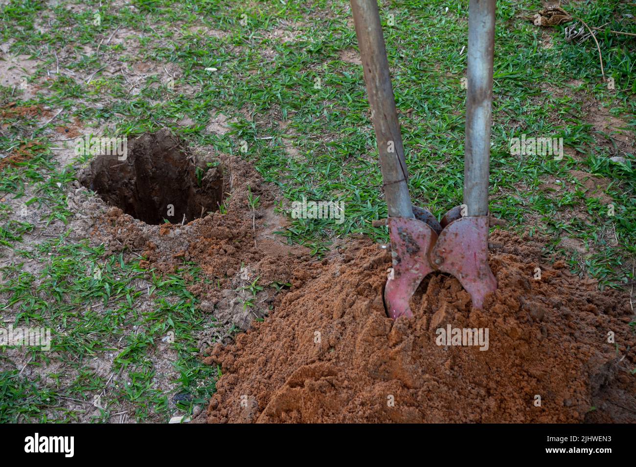 Well dug in the sandy soil. Tool for making round holes. artificial