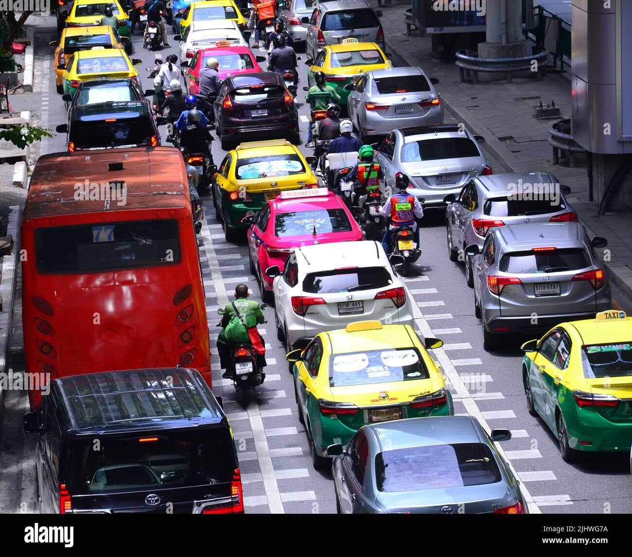 Traffic jam of cars, motorbikes and a bus on Silom Road, Bangkok, Thailand, Asia, as drivers of vehicles struggle to make progress in daytime busy traffic. Stock Photo