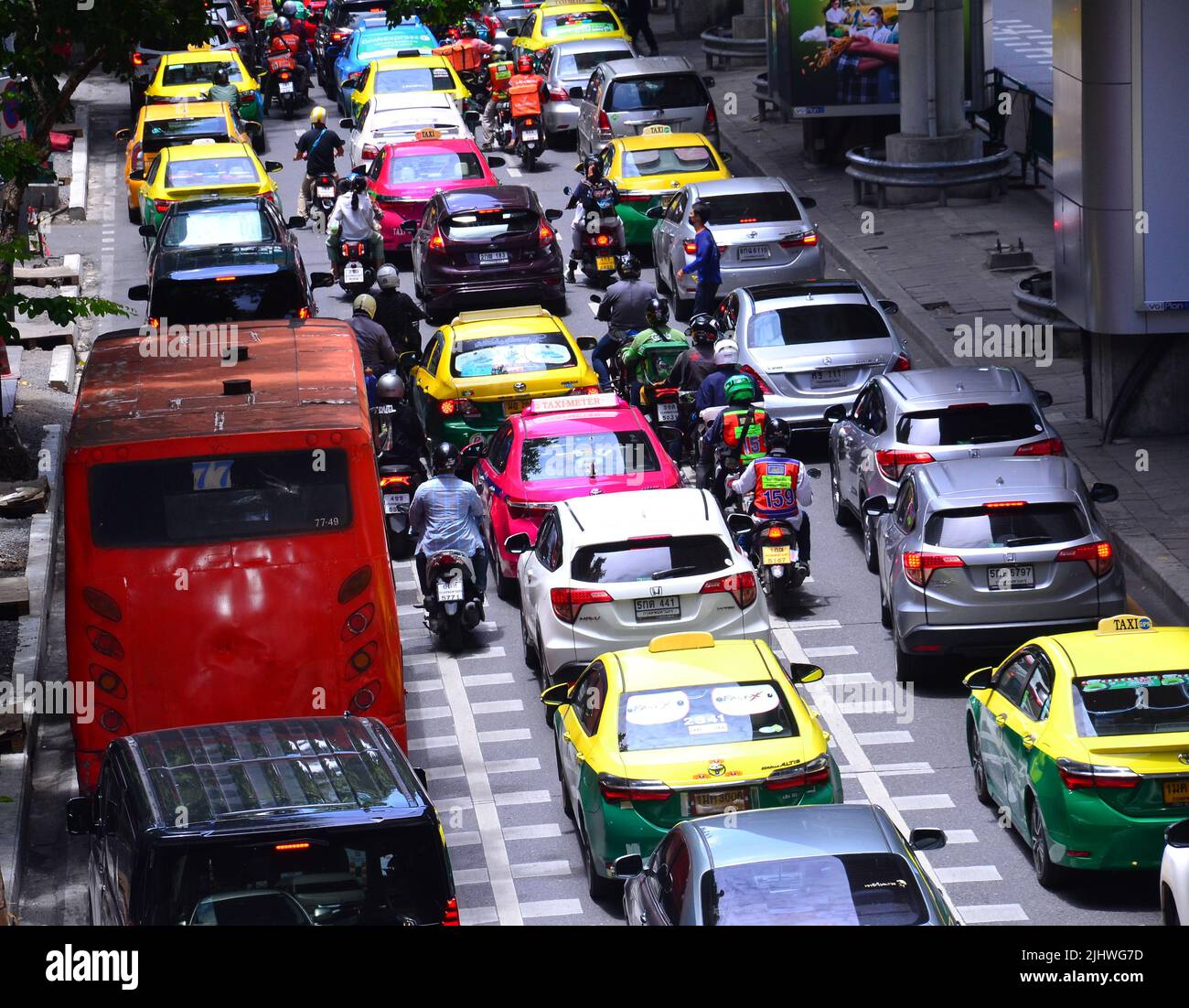Traffic jam of cars, motorbikes and a bus on Silom Road, Bangkok, Thailand, Asia, as drivers of vehicles struggle to make progress in daytime busy traffic. Stock Photo