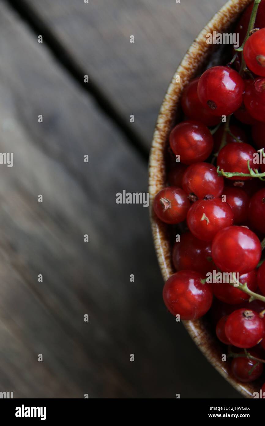 Ripe red currant in a cup on vintage background Stock Photo