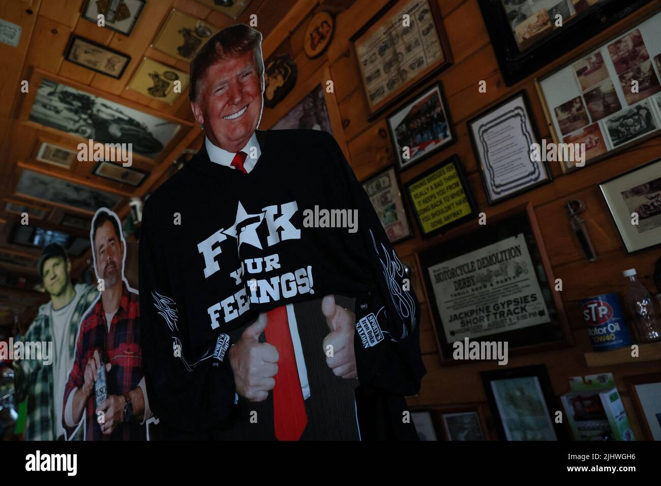 A cutout cardboard figure former U.S. President Donald Trump stands with other memorabilia at Sporty's Iron Duke Saloon in Minerva, New York, U.S., July 20, 2022. REUTERS/Shannon Stapleton Stock Photo