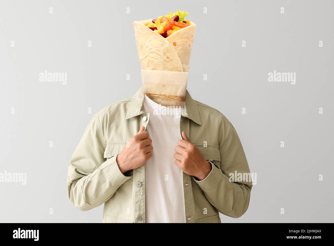 Young man with tasty burrito instead of his head on light background