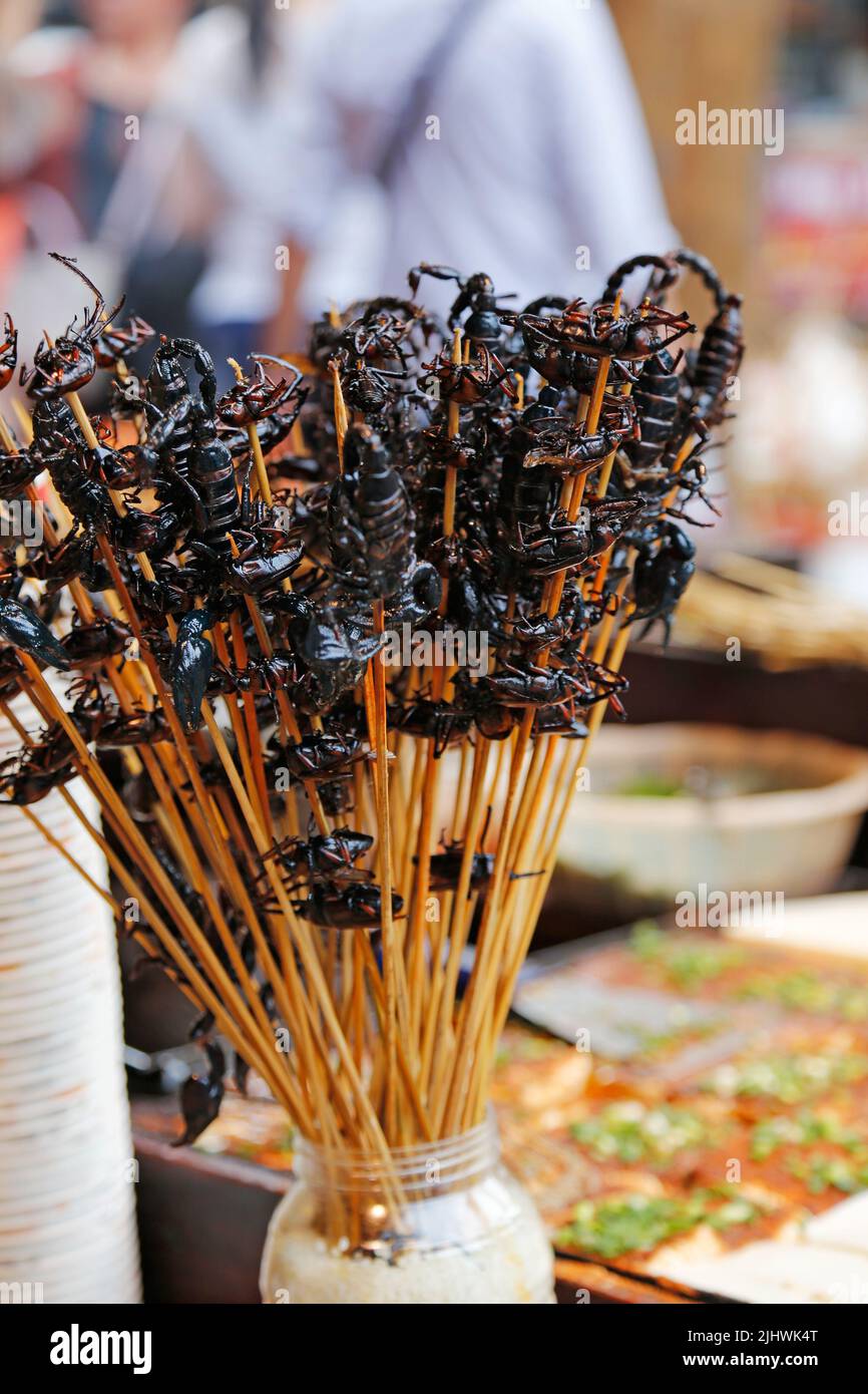 Bizarre food at the street booth in Asia - fried scorpions Stock Photo
