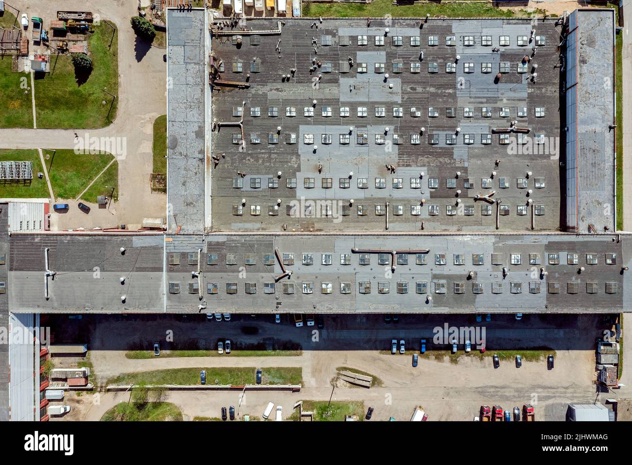 territory of an industrial plant. factory roof with skylights and ventilation system. view from above. Stock Photo