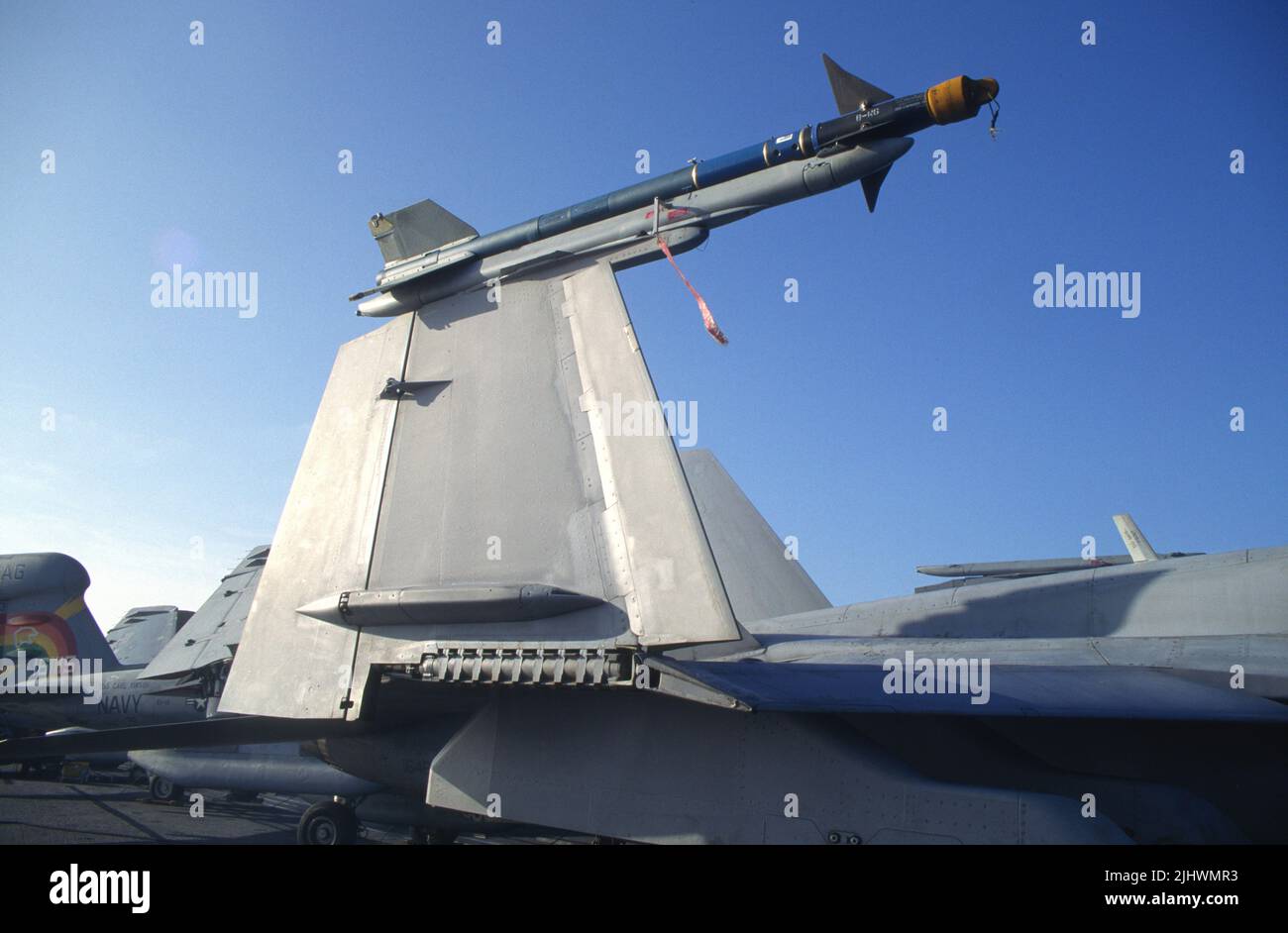 Folded wing on an F/A18 with mounted practice missile aboard aircraft carrier Stock