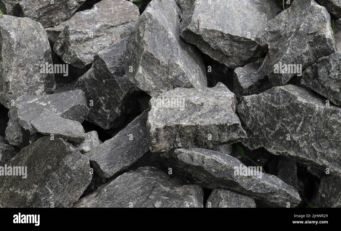 Large pieces of granite stone stack one another for sell use as building material Stock Photo