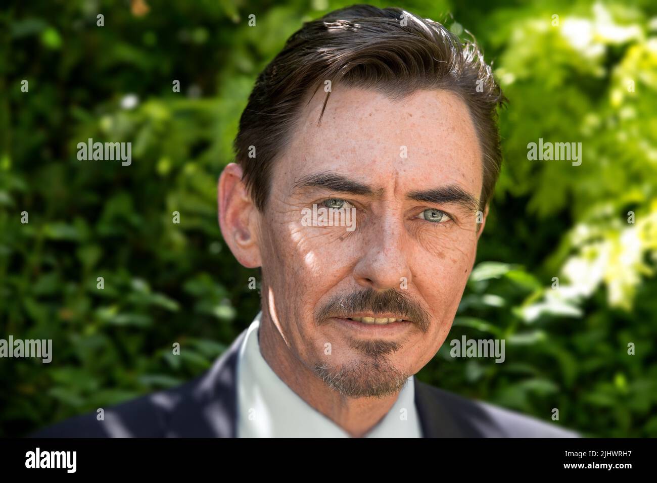 Natural light portrait of middle aged businessman with intense green eyes Stock Photo