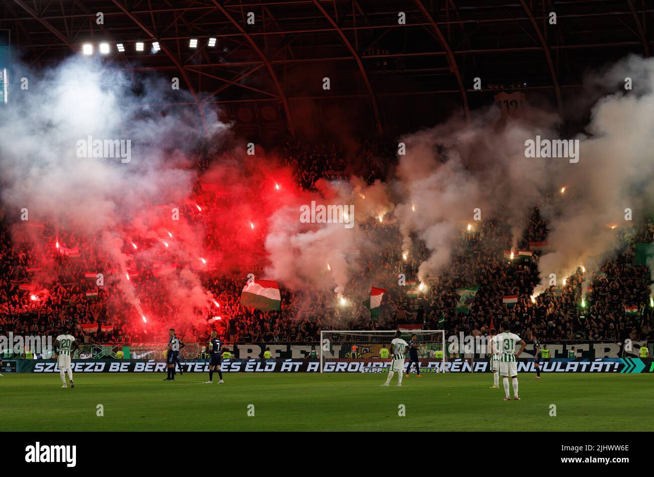 BUDAPEST, HUNGARY - JULY 20: Supporters of Ferencvarosi TC wave flares during the UEFA Champions League Second Qualifying Round First Leg match between Ferencvarosi TC and SK Slovan Bratislava at Ferencvaros Stadium on July 20, 2022 in Budapest, Hungary. Stock Photo