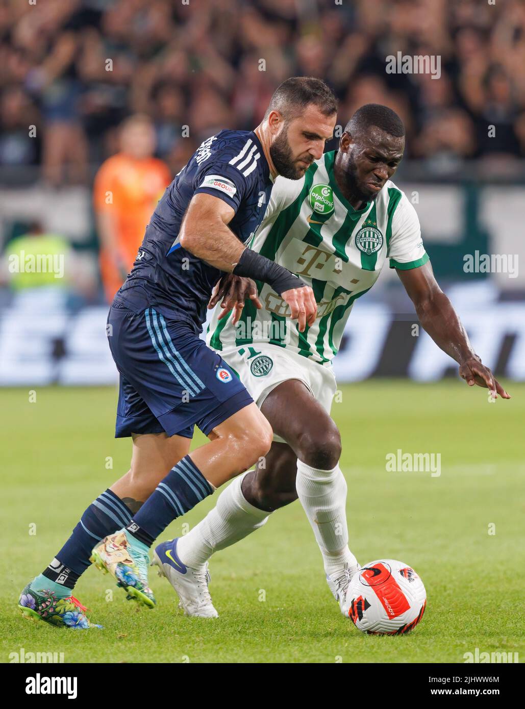 BUDAPEST, HUNGARY - JULY 13: Aleksa Amanovic of FC Tobol challenges  Kristoffer Zachariassen of Ferencvarosi TC during the UEFA Champions League  2022/23 First Qualifying Round Second Leg match between Ferencvarosi TC and