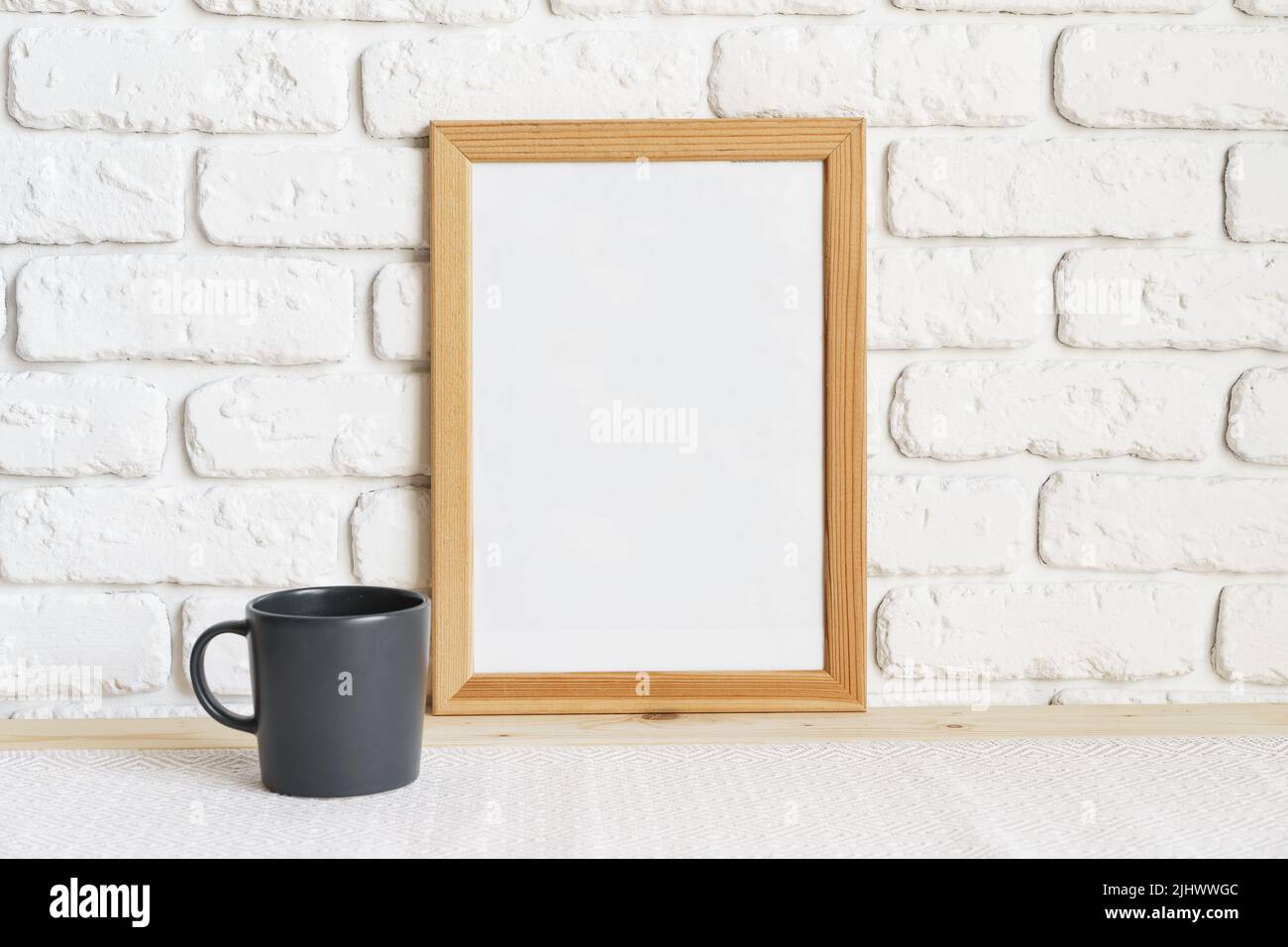 Photo frames on floor over white brick wall Stock Photo