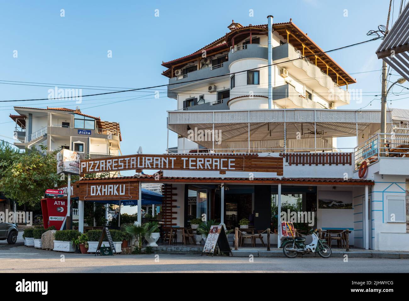 Ksamil, Albania - September 9, 2021: Street view of Ksamil at day with the Restaurant Pizza Oxhaku near the hotels in Ksamil, Albania. Stock Photo