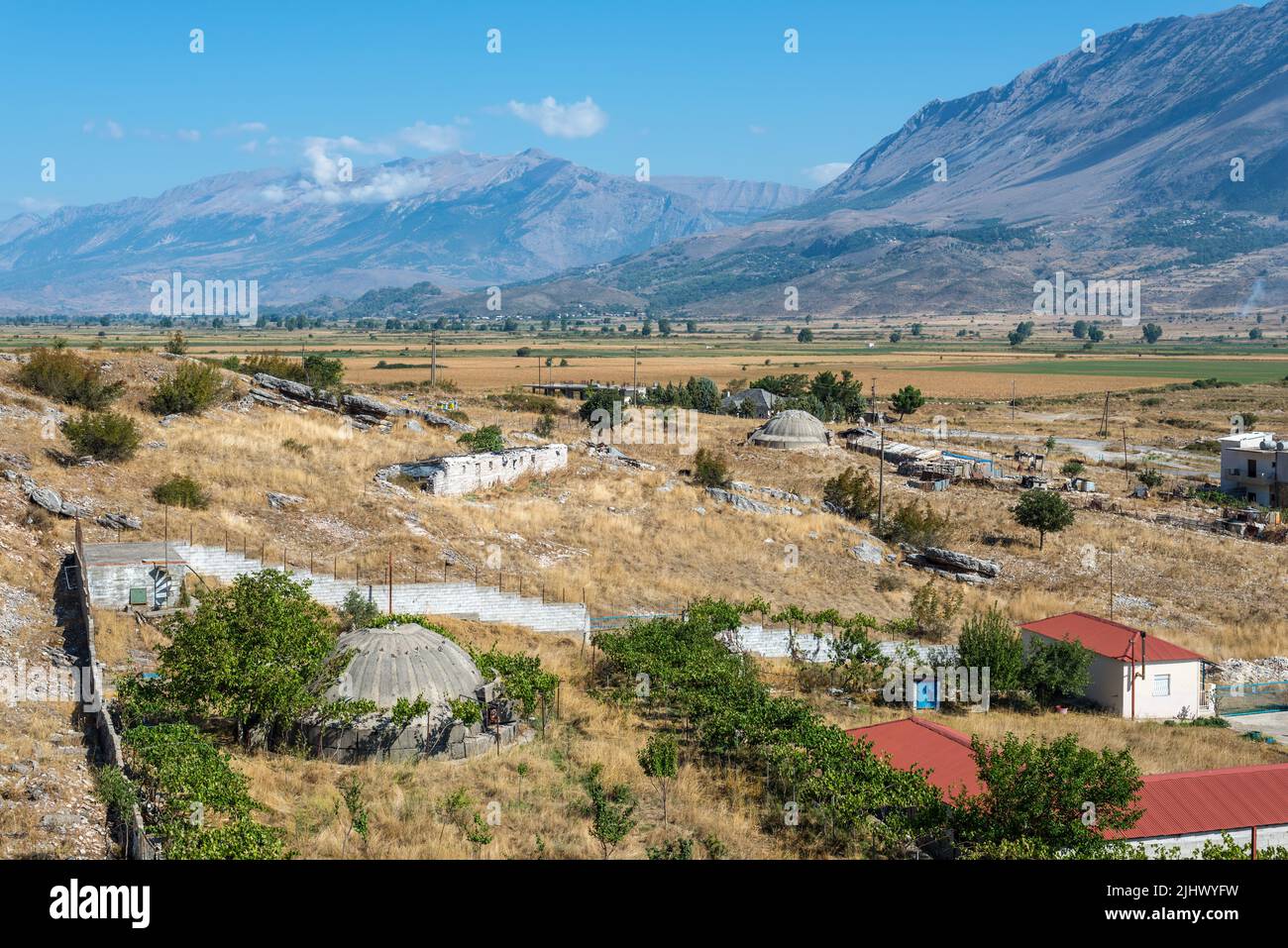 Jorgucat, Albania - September 10, 2021: Landscape with concrete military bunkers in Albania. The bunkers were built by during the cold war by the comm Stock Photo