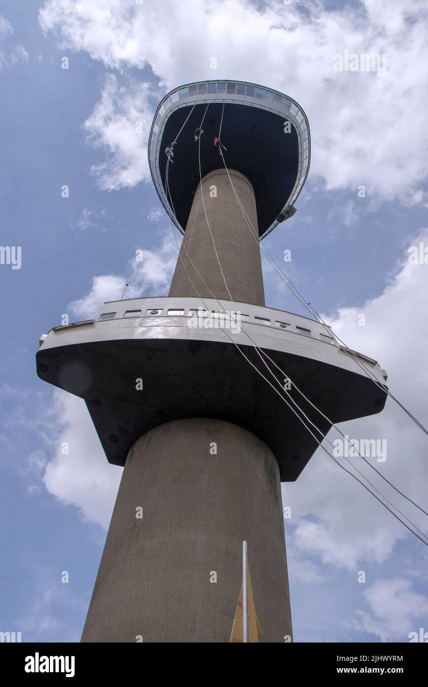 Three young People abseiling down the Euromast tower in Rotterdam Stock Photo