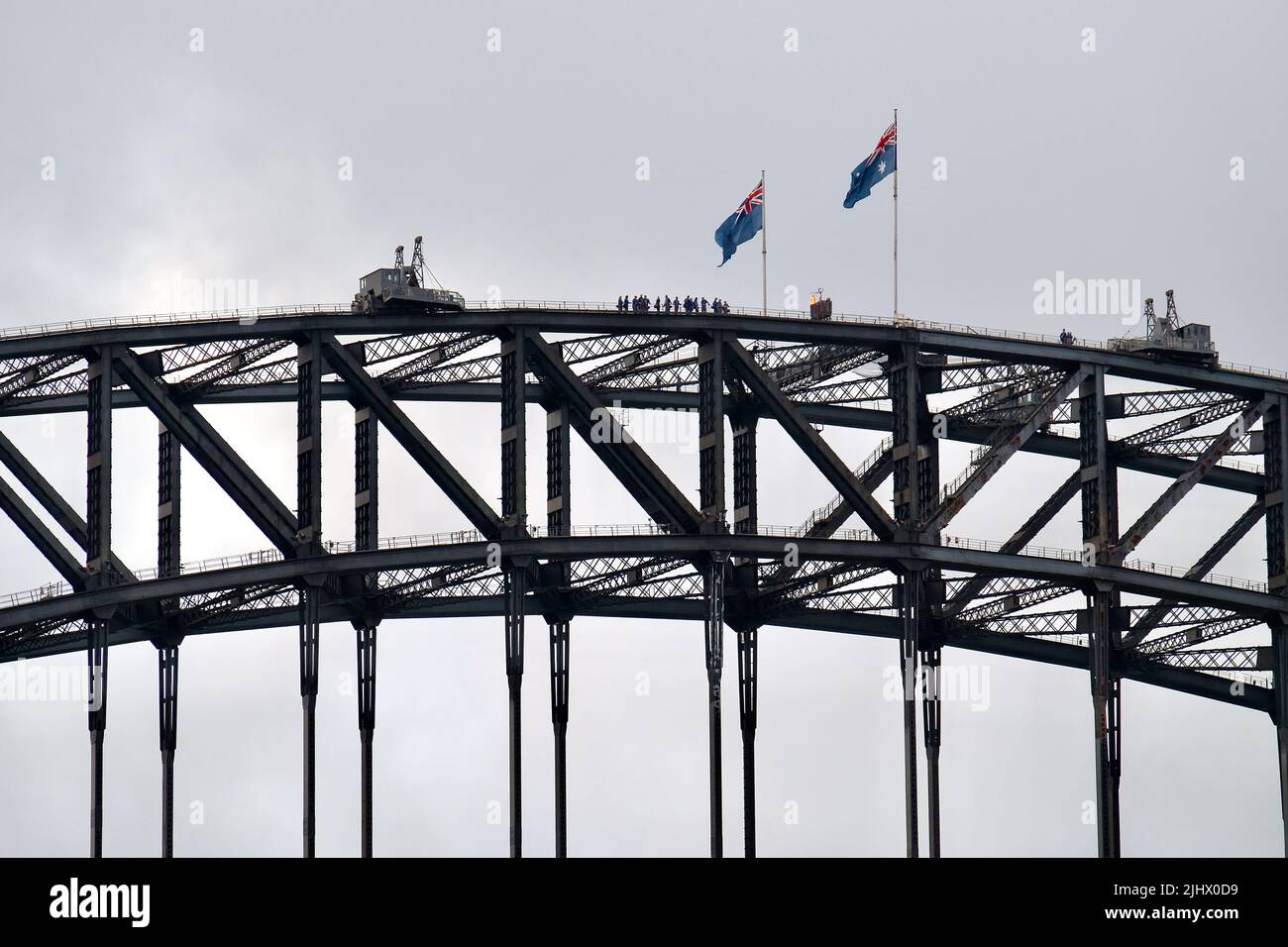 Tourists atop the upper arch of the Sydney Harbour Bridge in Sydney, Australia. Scaling the iconic 134m high bridge is a popular tourist activity. Stock Photo