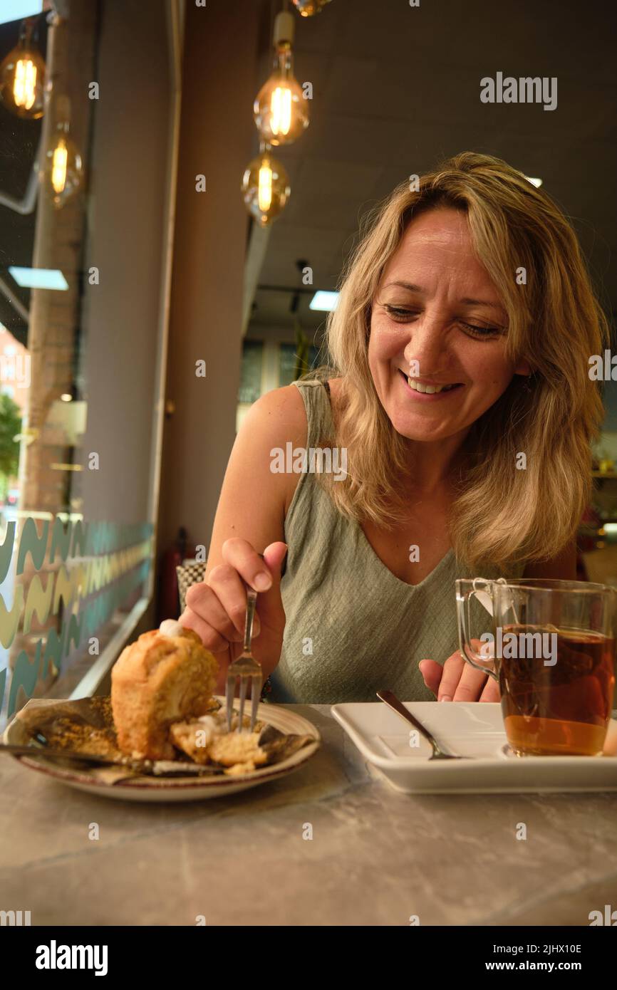 a girl drinks for an hour in a cafe Stock Photo Alamy