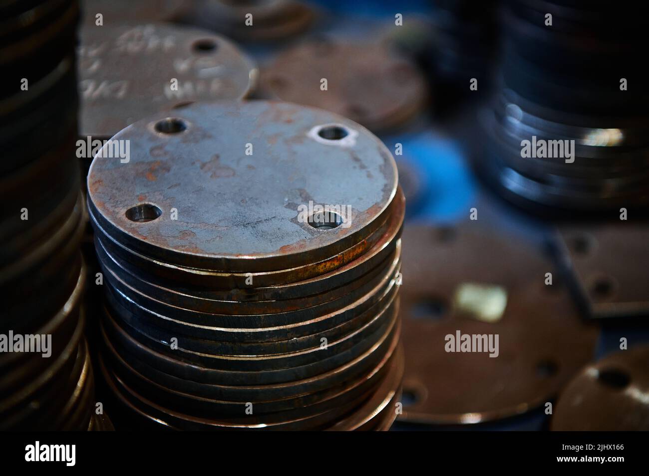 Piles of different workpieces made of metal material sheet Stock Photo