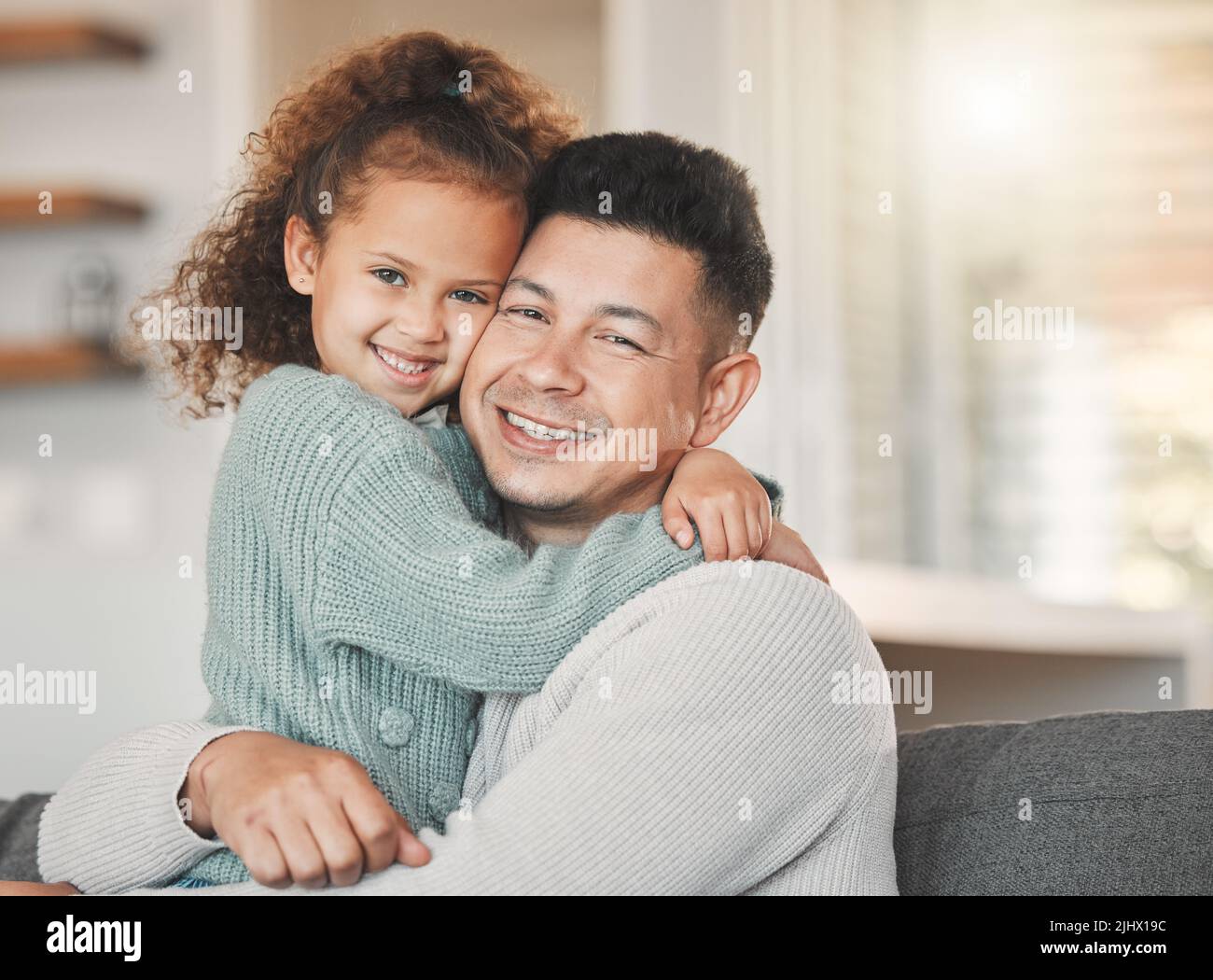 Family and friends are hidden treasures. a father and daughter on the sofa at home. Stock Photo
