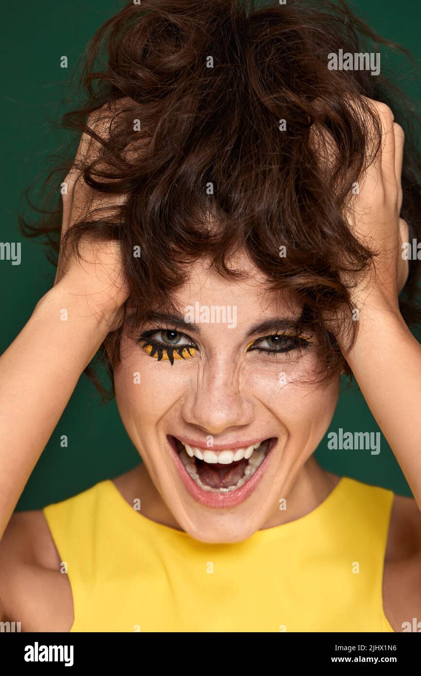 surprised woman in yellow dress starring with opened mouth Stock Photo ...