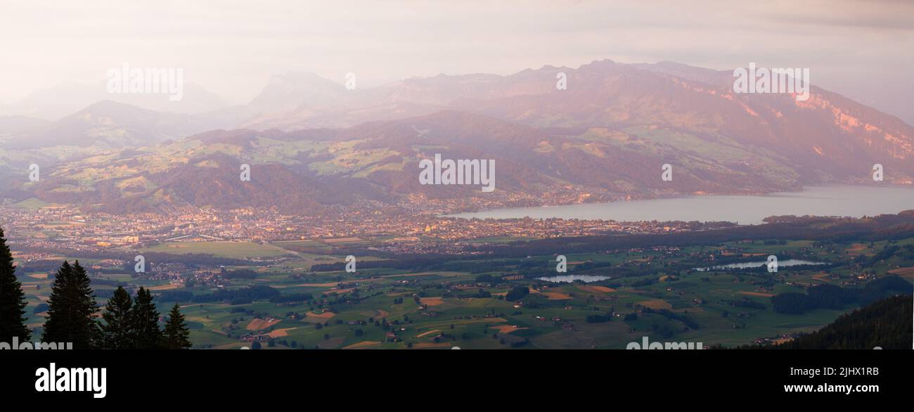 panoramic view over Thun and Lake Thun seen from Gantrisch during a summer sunset Stock Photo