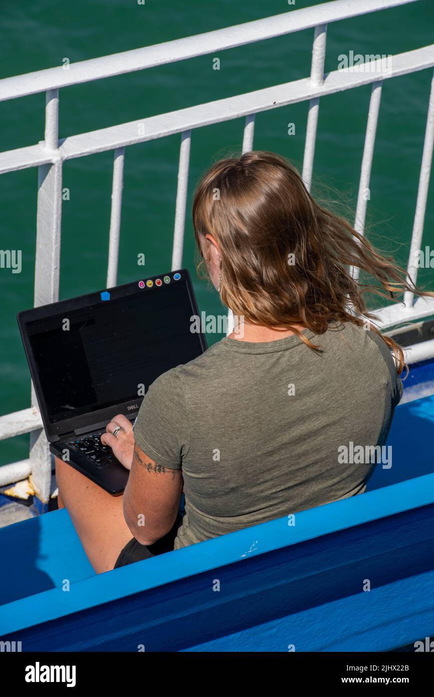 young woman using computer out of doors, young lady with laptop ...