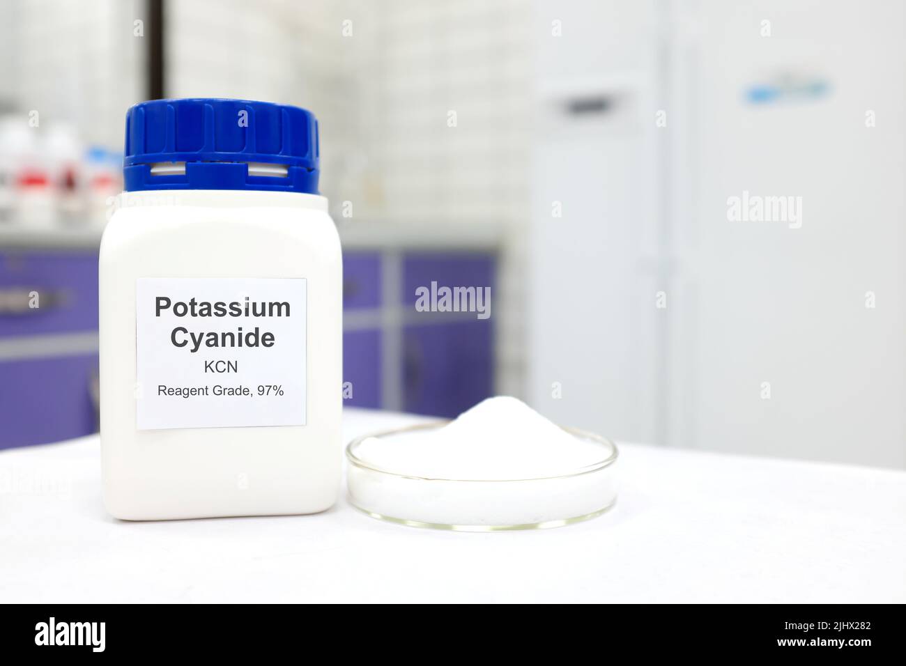 Selective focus of a bottle of Potassium Cyanide pure chemical compound. White laboratory background. Stock Photo