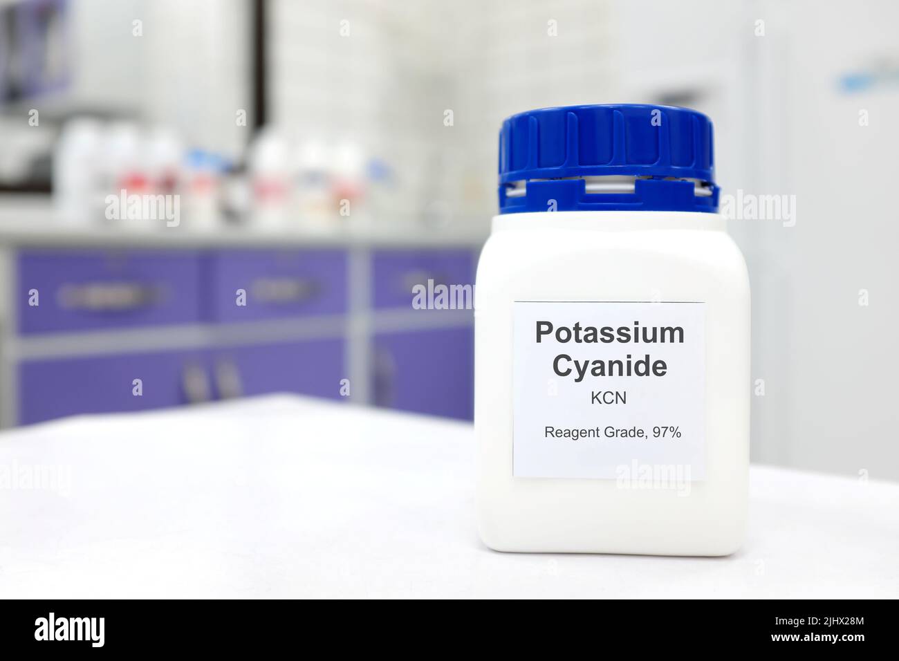 Selective focus of a bottle of Potassium Cyanide pure chemical compound. White laboratory background. Stock Photo