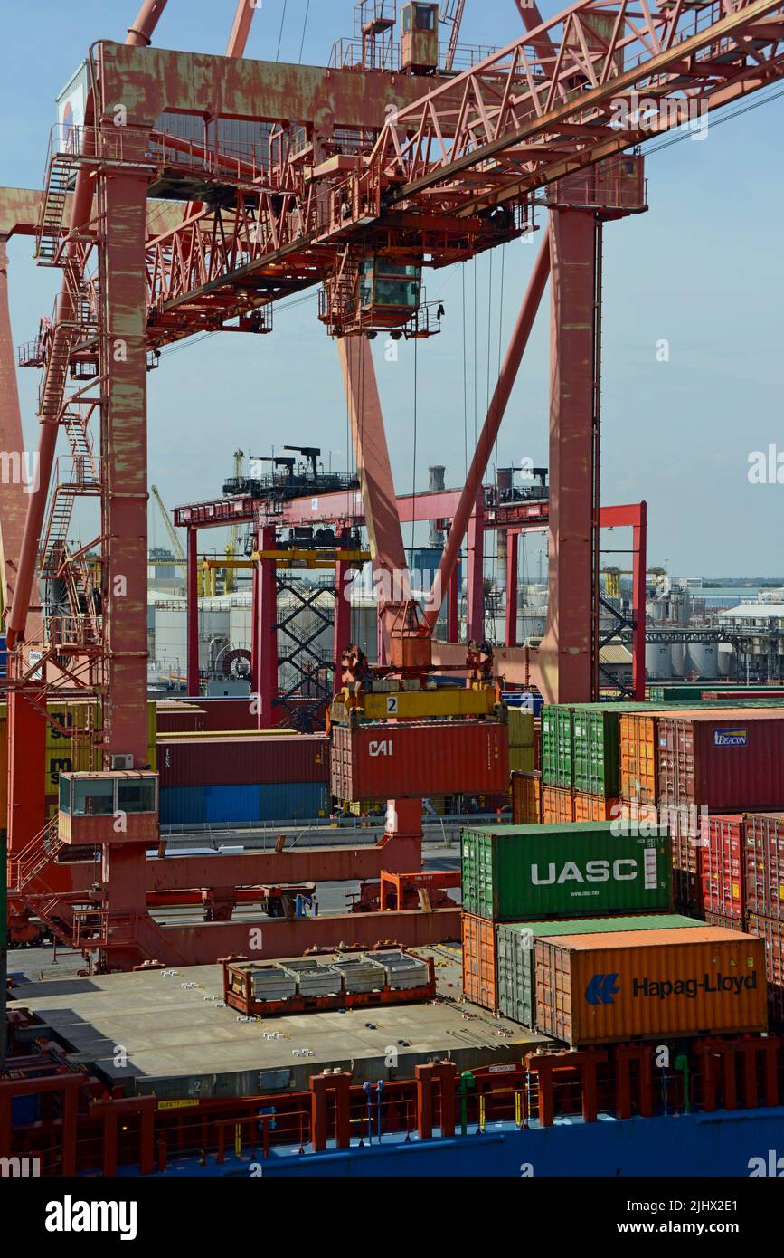 Harbour container crane unloading shipping containers in Dublin Port