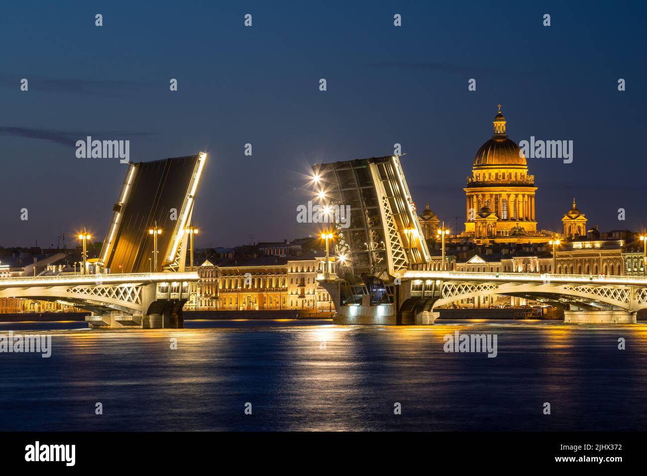 White nights in St. Petersburg. St. Isaac's Cathedral and the divorced Annunciation Bridge. Beautiful night cityscape Stock Photo