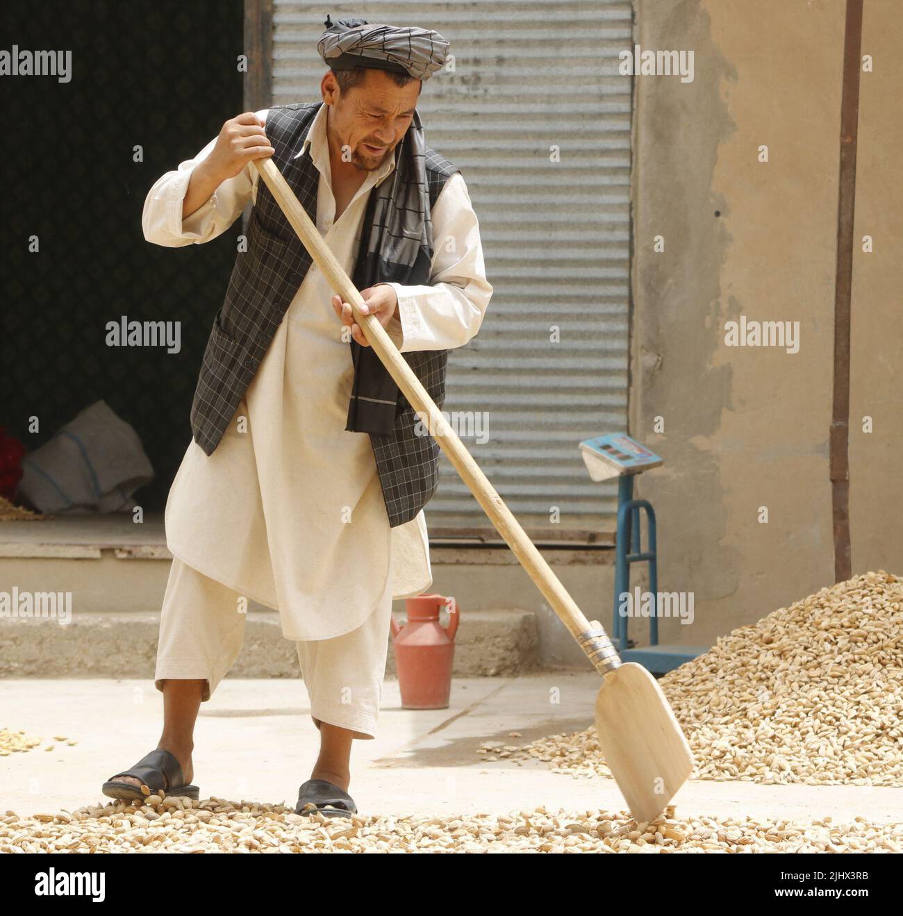 Samangan, Afghanistan. 20th July, 2022. An Afghan farmer works at an almond processing workshop in Samangan province, Afghanistan, July 20, 2022. Credit: Khibar Momand/Xinhua/Alamy Live News Stock Photo