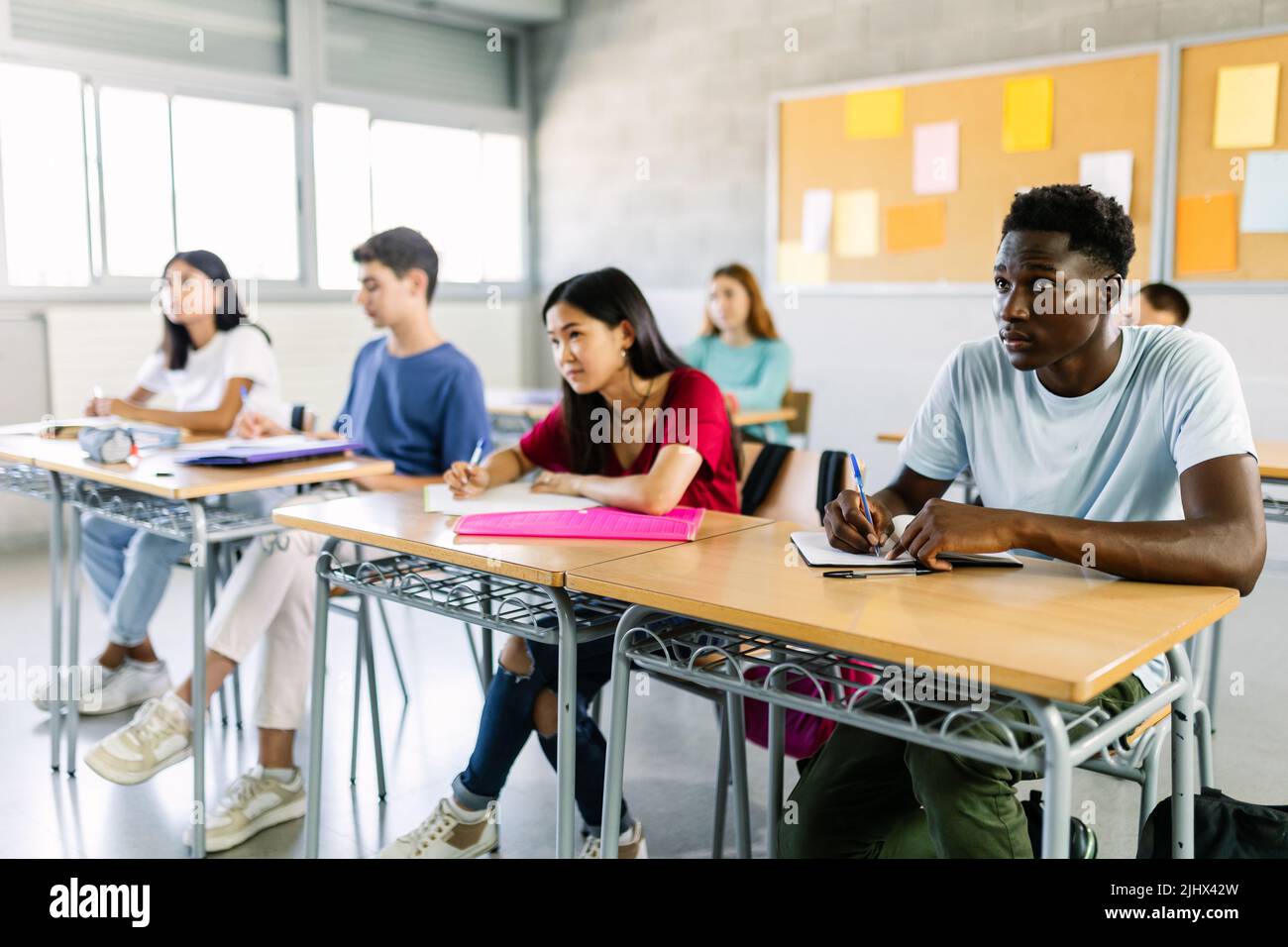 Multiracial group of student people listening teacher in classroom at school Stock Photo