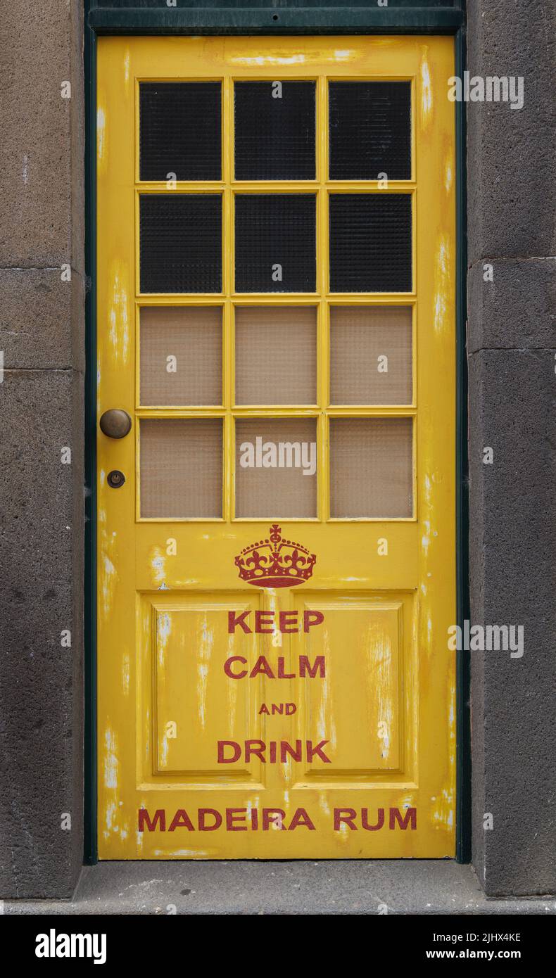 'Keep calm and drink Madeira Rum', painted front door in Funchal old town, Madeira, Portugal Stock Photo