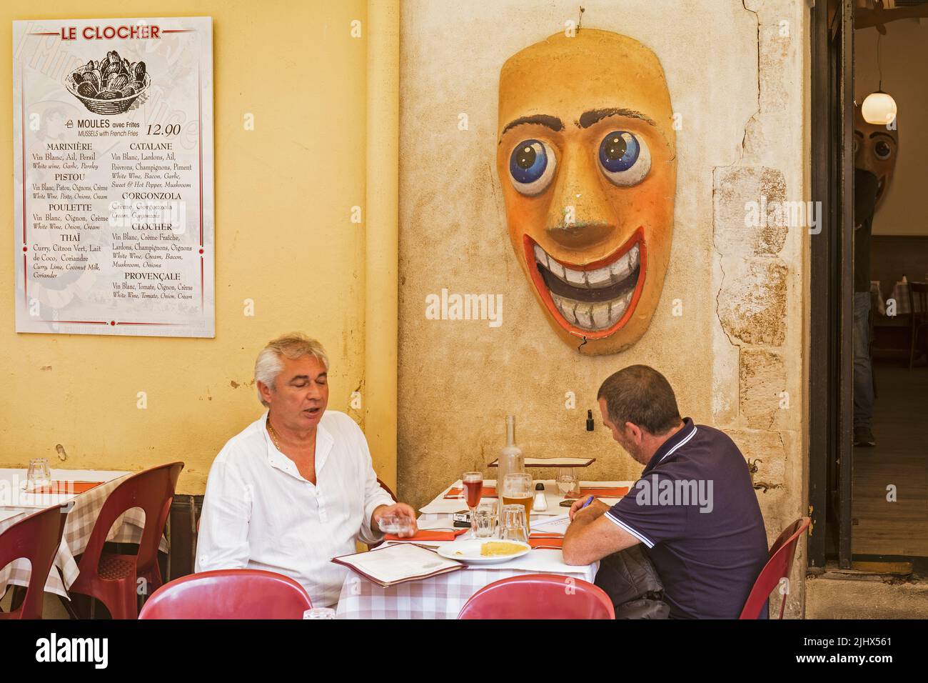 Two men in discussion over drinks and snacks on terrace of  Le Clochet restaurant, Nice, France.  EDITORIAL ONLY Stock Photo