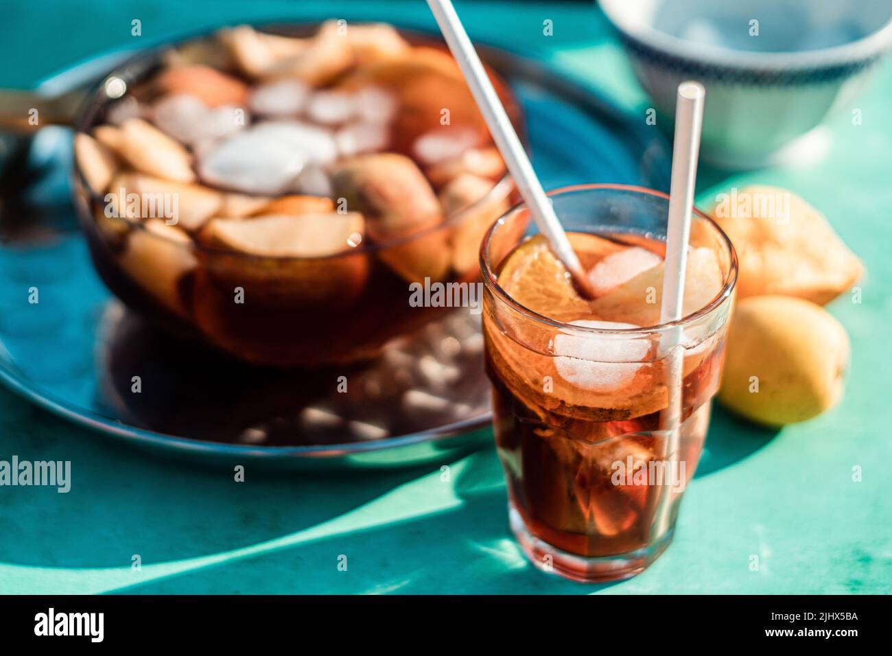 A high-angle view of a fresh cocktail with fruits and ice cubes on a ...