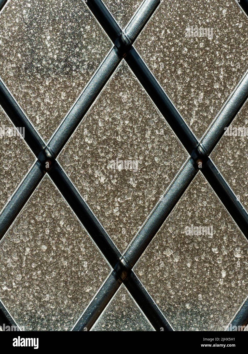 Backlit view of sahara dust on a lattice window, Cambridgeshire, England Stock Photo