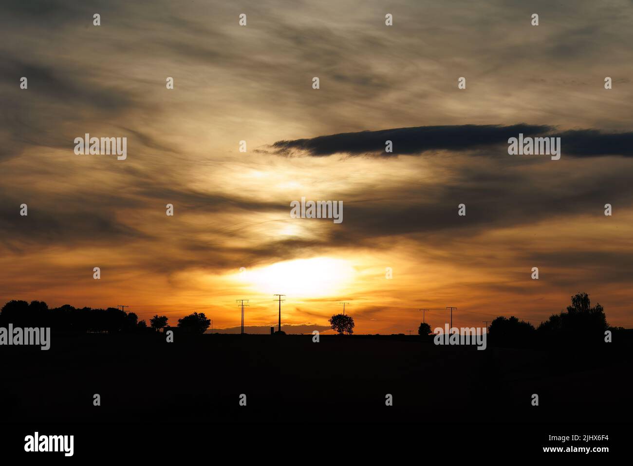 A beautiful dramatic sunset in the cloudy sky Stock Photo - Alamy