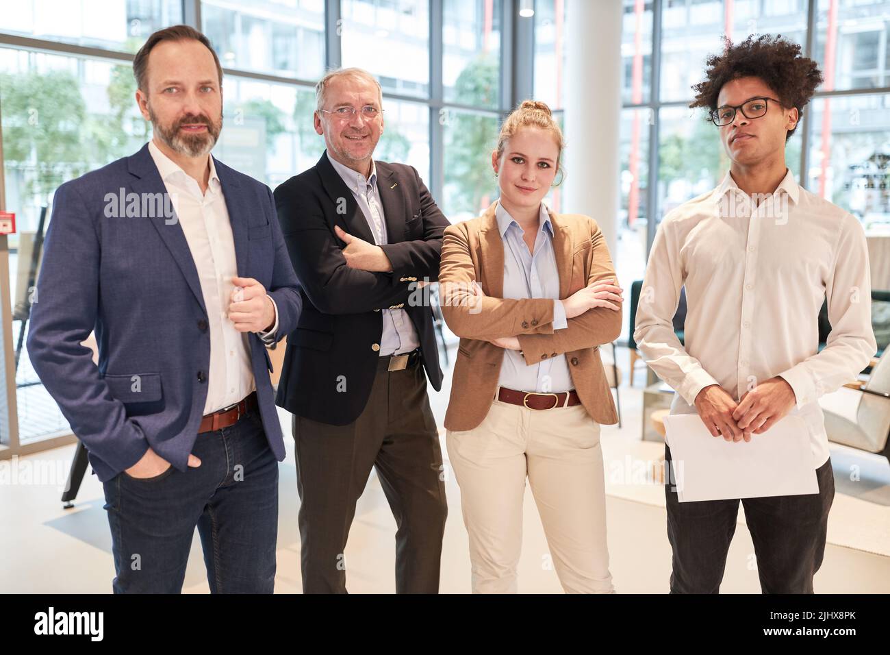 Confident and successful business team with senior boss and young colleagues Stock Photo