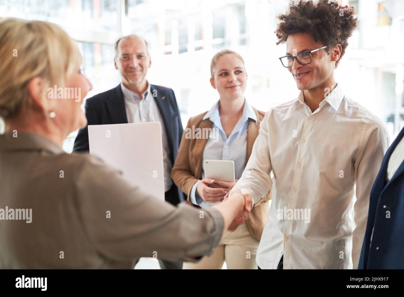 Start-up founder and business woman shaking hands for partnership or greeting Stock Photo