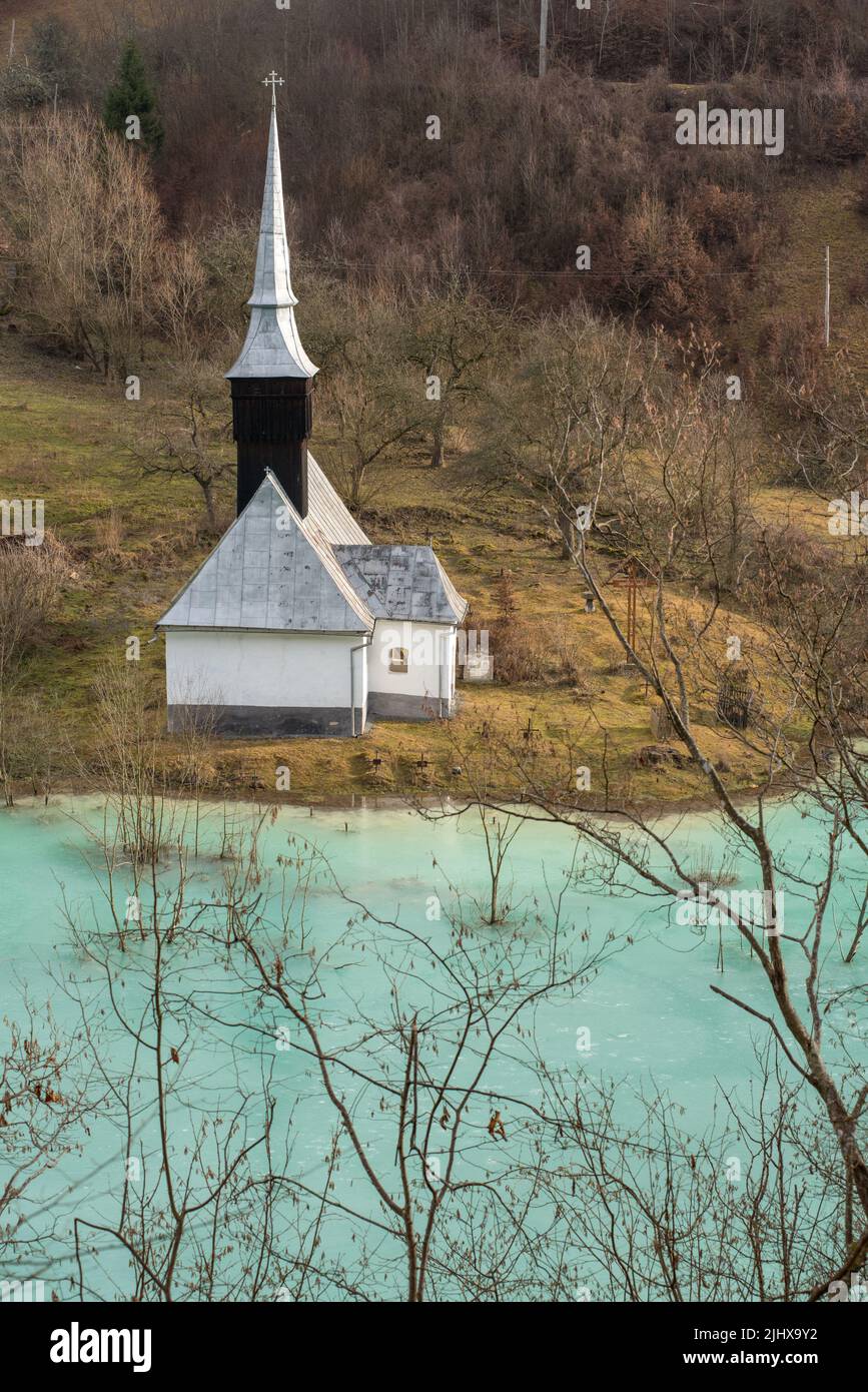 Toxic waste waters from a copper and gold mine submerge village. Abandoned orthodox church on lakeside. Geamana, Rosia Montana, Romania Stock Photo