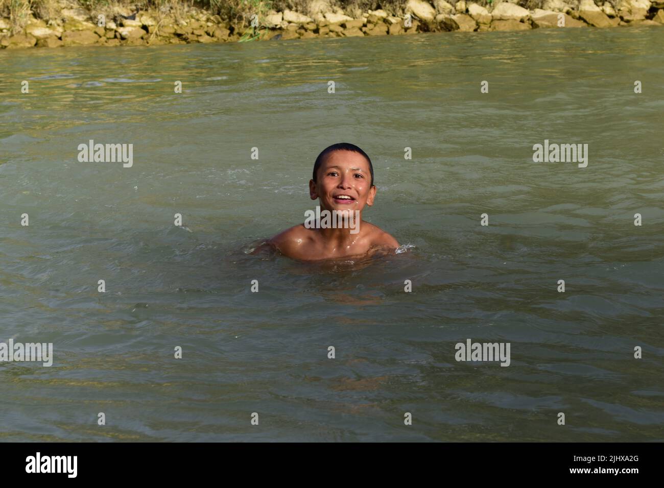 Indonisaian  boy river swim alamy 