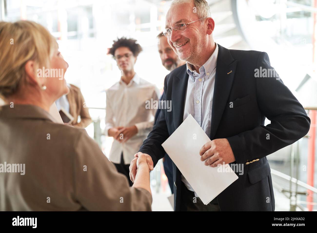 Senior business man as manager shaking hands for greeting or joint venture Stock Photo
