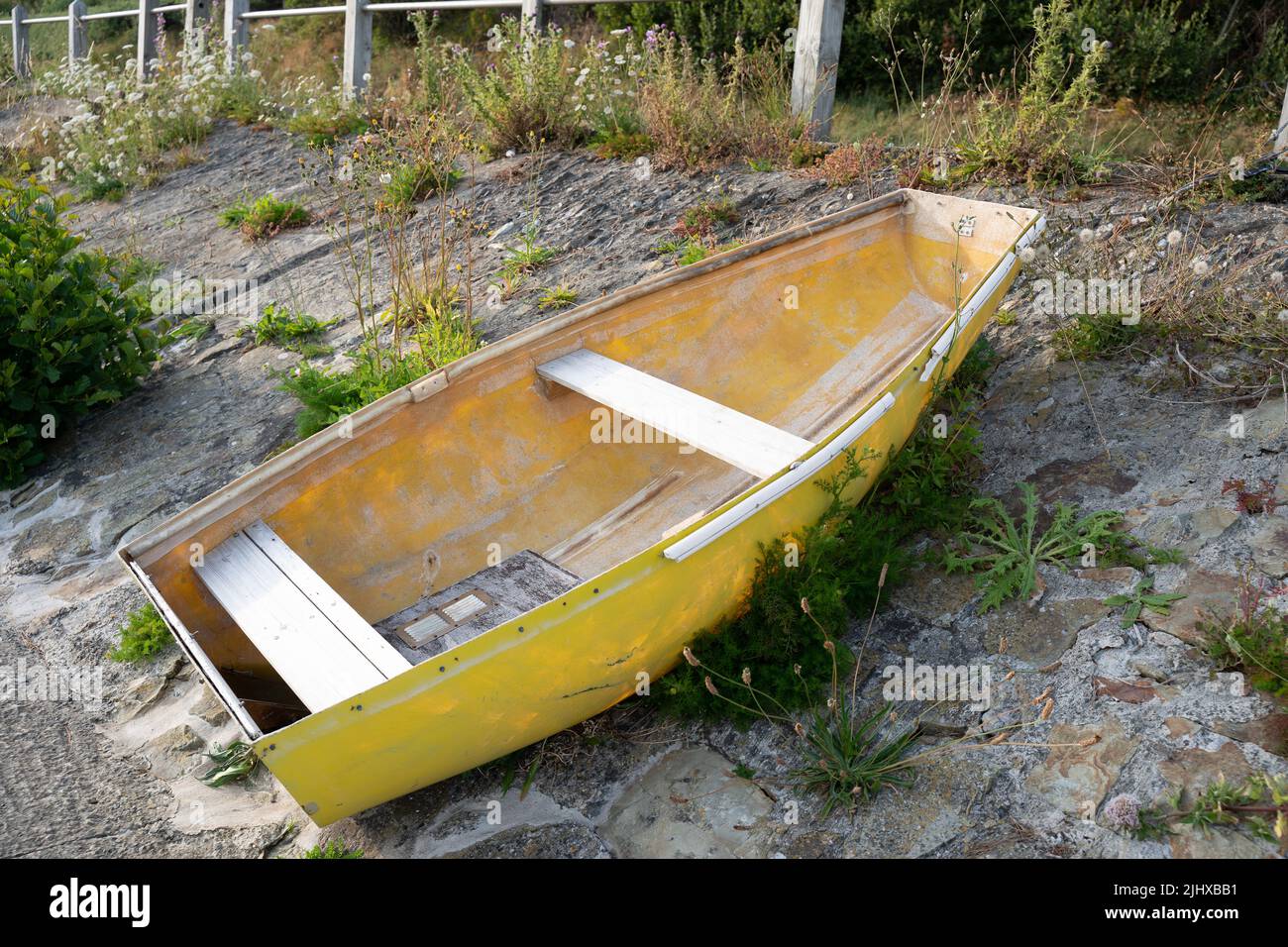 small yellow fishing boat on the banks of the river Teifi in cardigan west wales Stock Photo