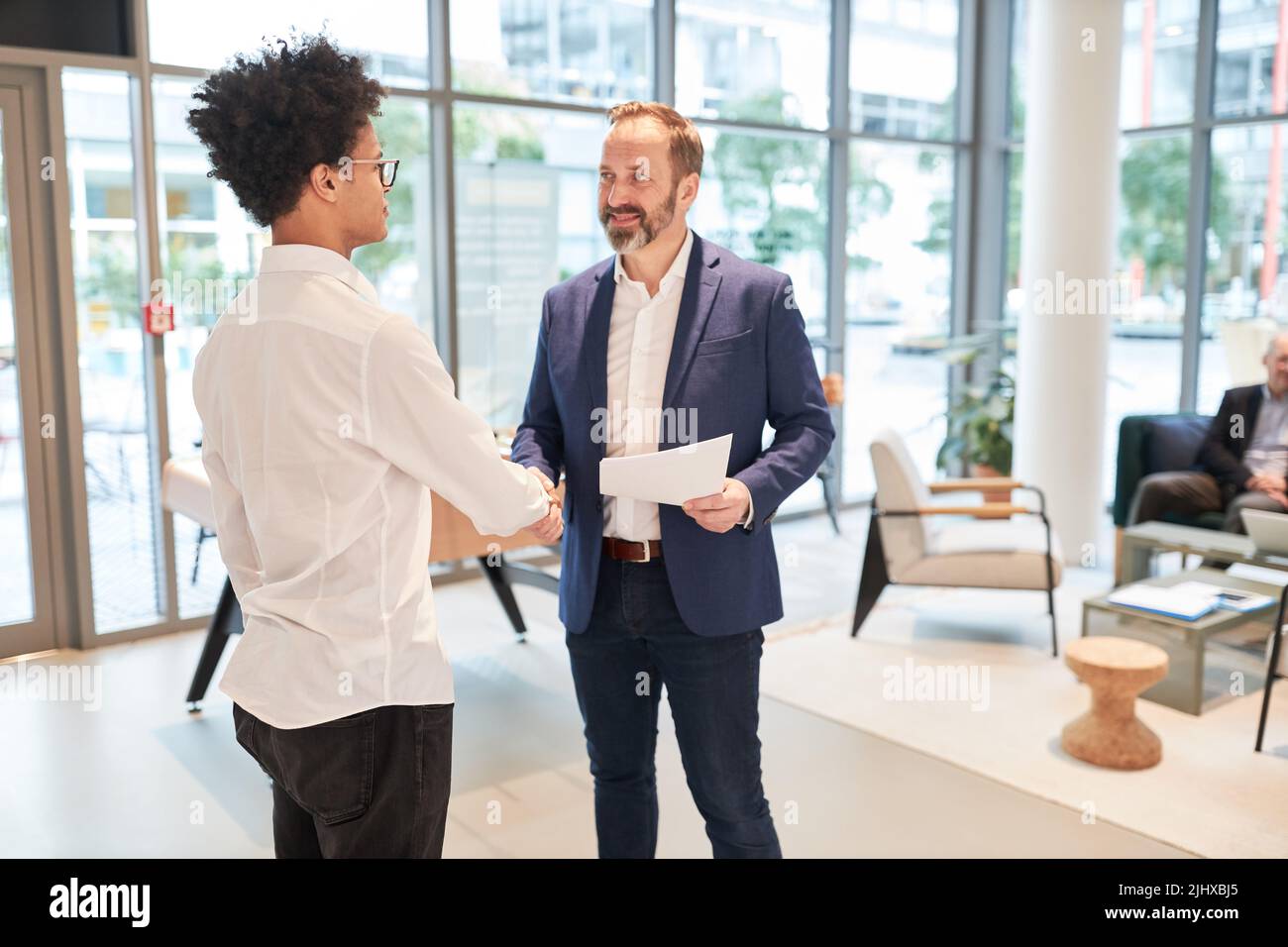 Two business people shaking hands in greeting and for good cooperation Stock Photo