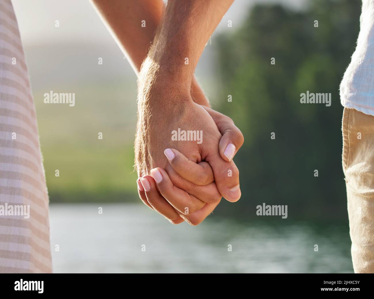 Hold tightly an unrecognizable couple holding hands while spending Hold tightly an unrecognizable couple holding hands while spending
