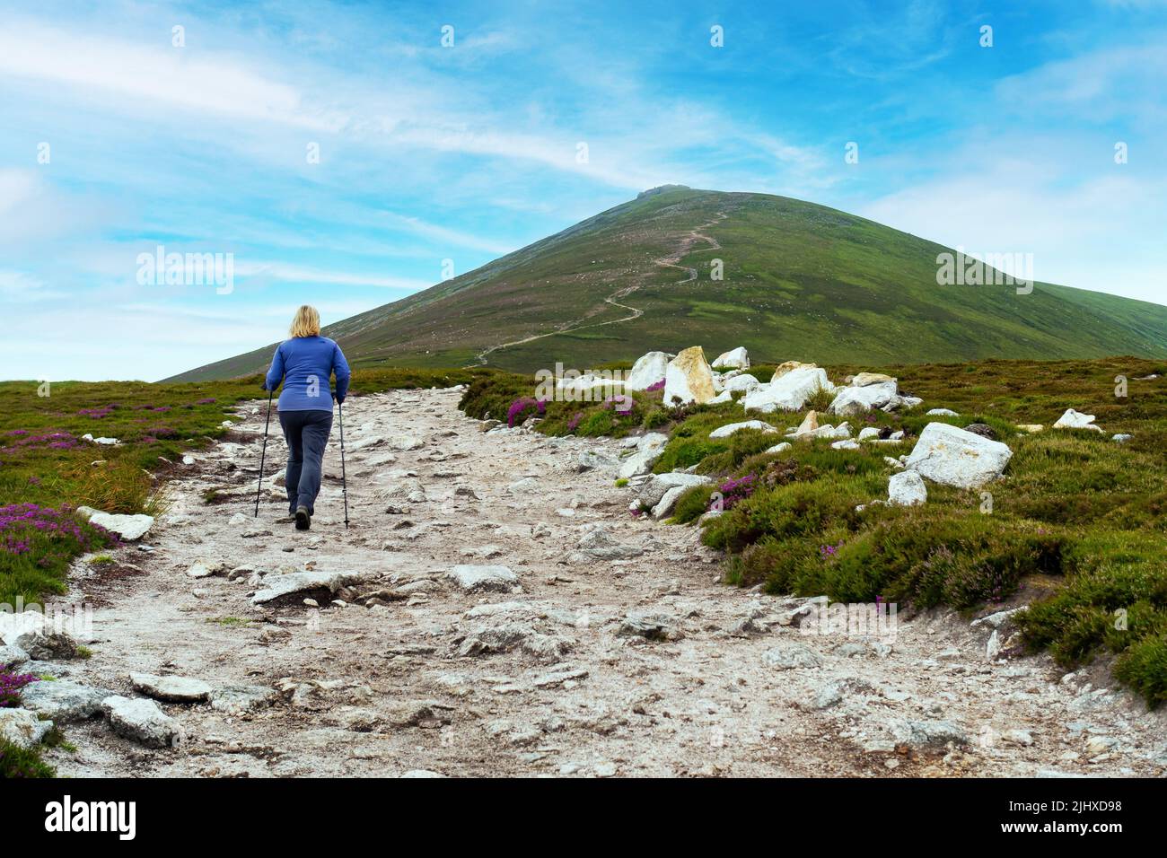 A walker ascending the path up to the corbett mountain of Ben Rinnes near Dufftown, Morayshire, Scotland Stock Photo
