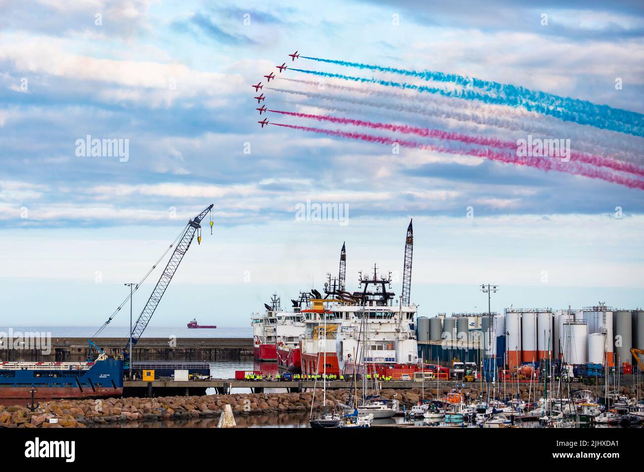 The RAF Red Arrows perform their display over Peterhead harbour in Aberdeenshire, Scotpand, as part of Scottish Week Stock Photo
