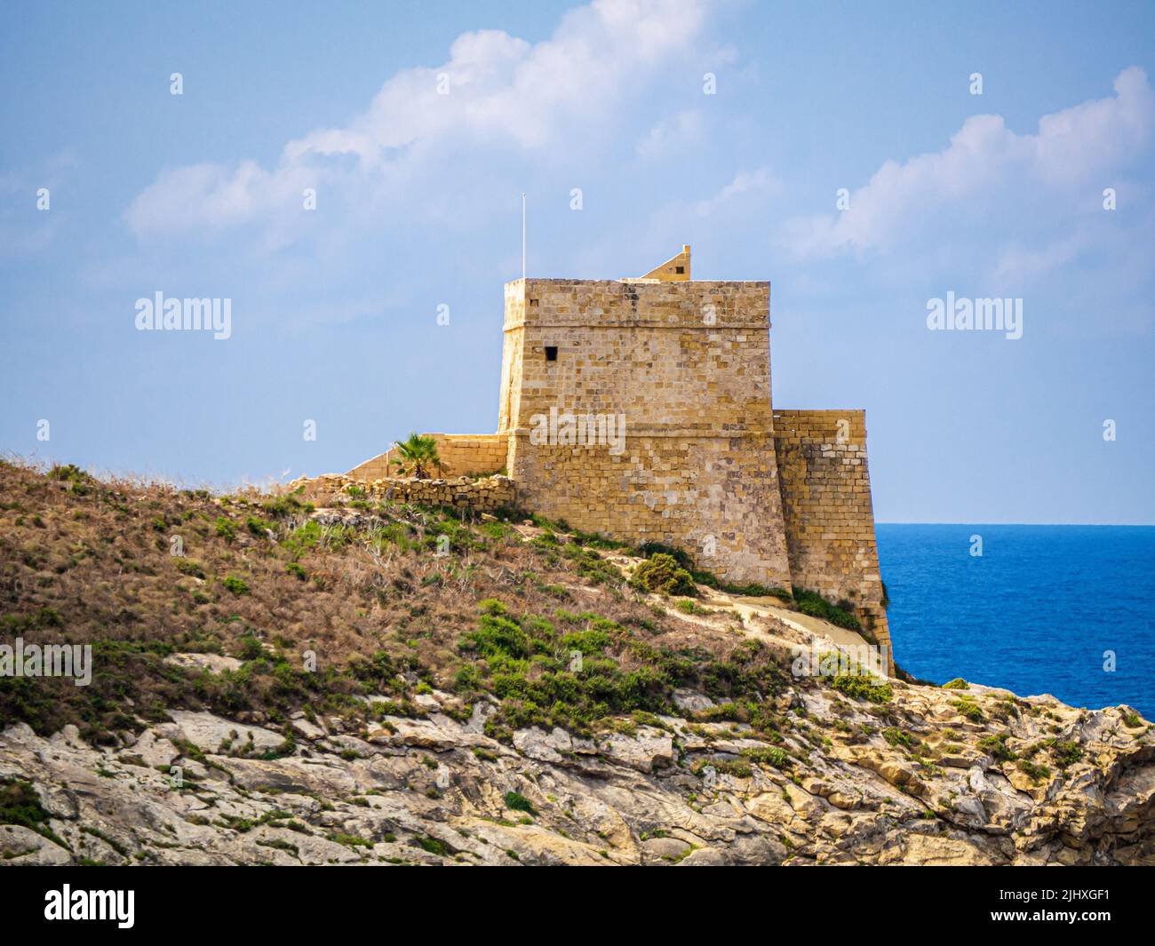 An aerial view of Xlendi Tower surrounded by rocks in background of sea in Malta Stock Photo Alamy