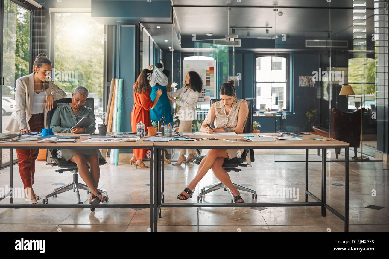 Collaborations bring new ideas. a group of female designers working in an office. Stock Photo