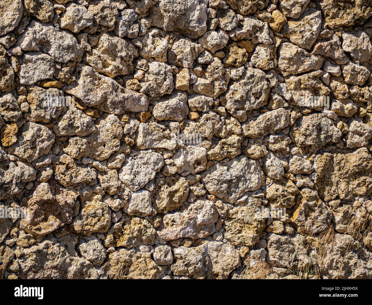 A texture of stone wall with rough uneven surface Stock Photo - Alamy