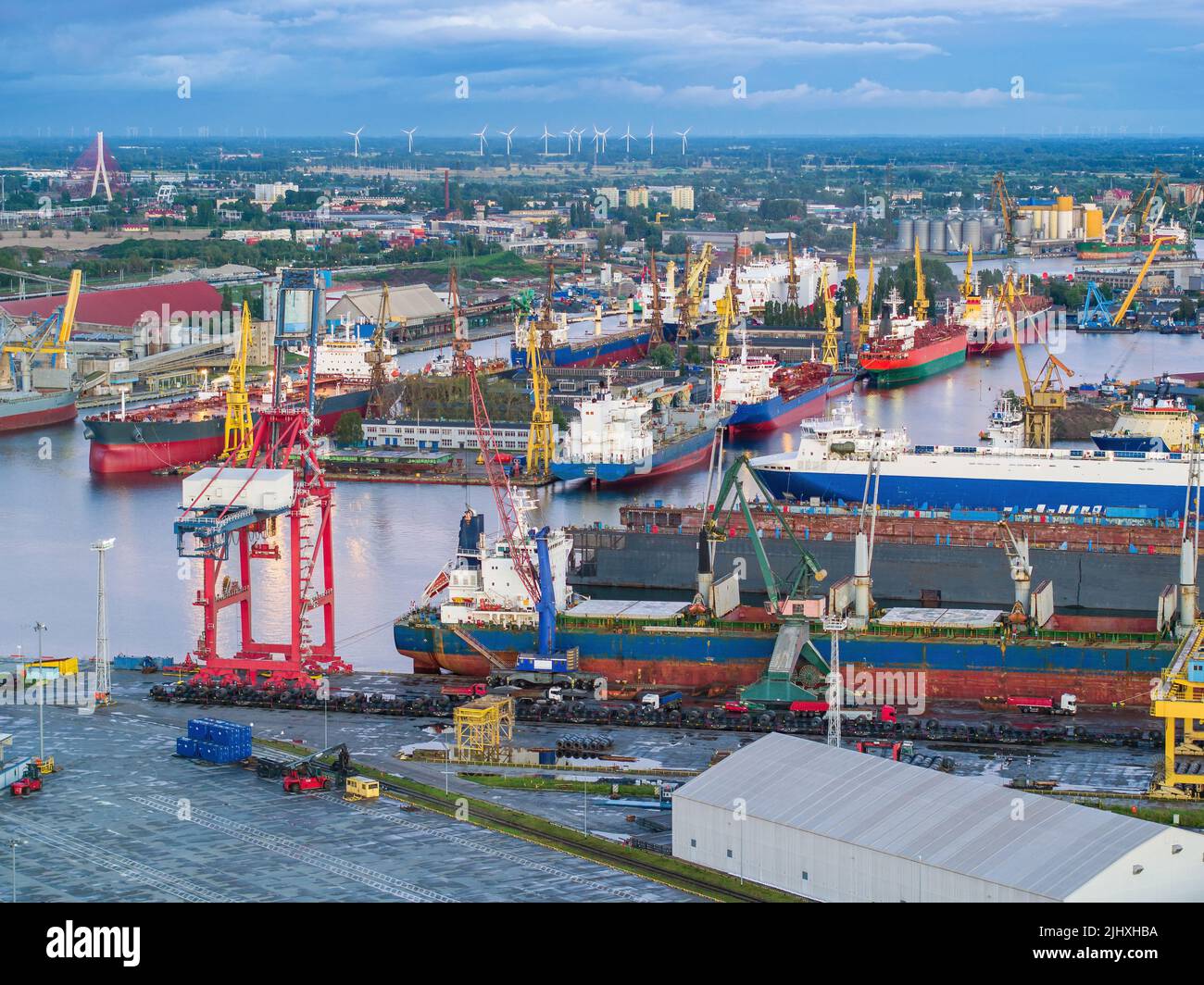 Shipyard aerial landscape of ships in docks under moody sky Stock